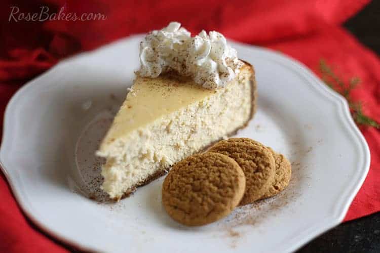 Eggnog Cheesecake with Gingersnap Crust on white dish with red backround