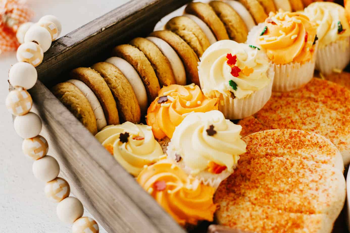 close up of cupcakes and sandwich cookies on the Thanksgiving dessert board